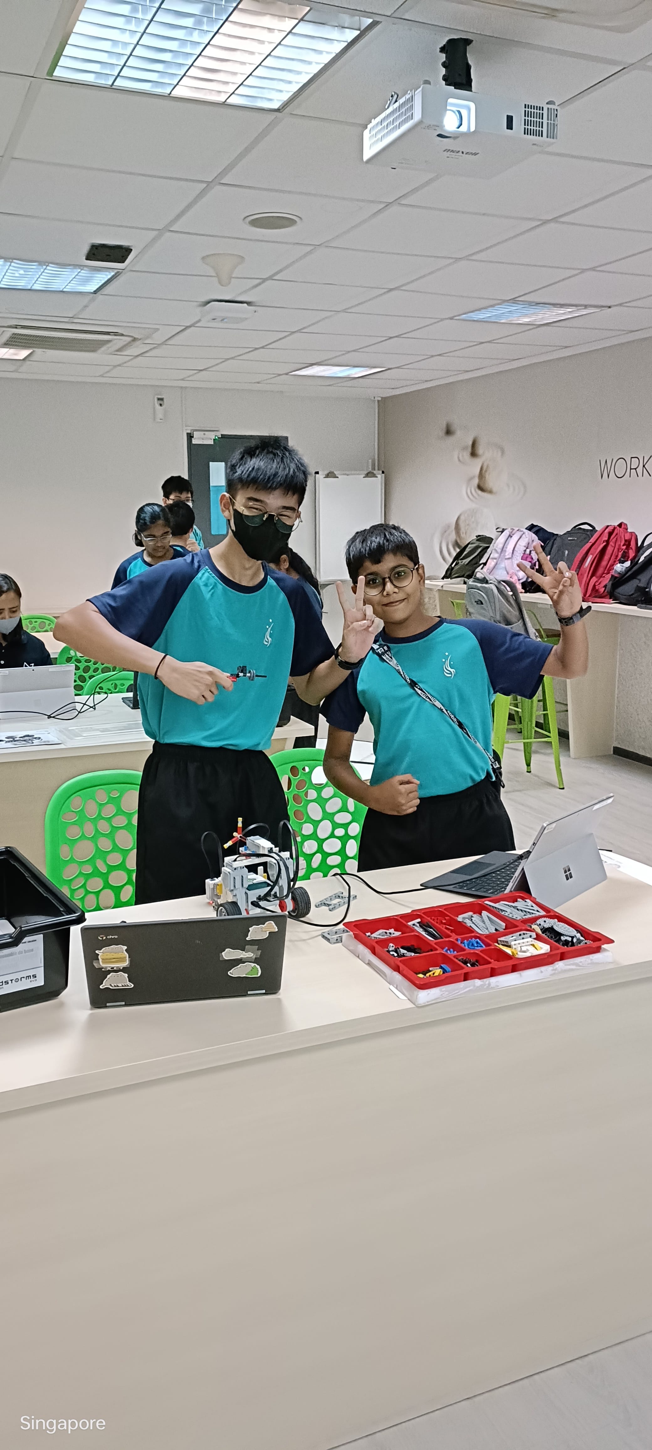 2 students posing with robotic equipment